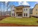 Two-story home featuring a spacious backyard and a charming wooden balcony, perfect for outdoor relaxation and entertainment at 4770 Briscoe Dr, Cumming, GA 30028