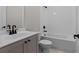 Stylish bathroom with a gray vanity, modern fixtures, and a white tiled tub and shower combo at 4770 Briscoe Dr, Cumming, GA 30028