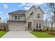 Charming two-story home with stone accents, gray shutters, and a well-manicured lawn at 4770 Briscoe Dr, Cumming, GA 30028