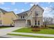 Charming two-story home with stone accents, gray shutters, and a well-manicured lawn at 4770 Briscoe Dr, Cumming, GA 30028