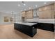 Gourmet kitchen with a large center island, light wood cabinets, and stainless steel appliances at 4770 Briscoe Dr, Cumming, GA 30028