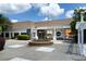 The Village Courtyard entrance with lush landscaping, a pergola, and multiple business entrances on a sunny day at 4824 Dunwoody Station Dr, Atlanta, GA 30338