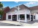 The pink exterior of Valor Coffee building, with dark framed windows and doors, on a sunny day at 4824 Dunwoody Station Dr, Atlanta, GA 30338