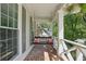 Cozy front porch with a swing and brick flooring, perfect for relaxation at 4824 Dunwoody Station Dr, Atlanta, GA 30338