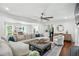 Spacious living room with a ceiling fan, dark hardwood floors, and comfortable seating at 4824 Dunwoody Station Dr, Atlanta, GA 30338