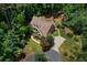 An aerial view of a brick house showcasing its dormer windows and driveway winding through lush greenery at 17 Shotgun Nw Rd, Cartersville, GA 30121