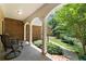 A covered patio featuring brick siding, classic columns, and a view of the tranquil backyard at 17 Shotgun Nw Rd, Cartersville, GA 30121