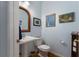 Powder room featuring pedestal sink, a mirror, and artistic decor at 17 Shotgun Nw Rd, Cartersville, GA 30121