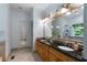 Bathroom featuring dual sinks with granite countertops and a large mirror at 17 Shotgun Nw Rd, Cartersville, GA 30121