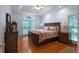Spacious bedroom with a tray ceiling, large windows, and hardwood floors at 17 Shotgun Nw Rd, Cartersville, GA 30121