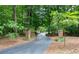 Long, private driveway winding through a wooded area with brick pillars marking the entrance to the property at 17 Shotgun Nw Rd, Cartersville, GA 30121