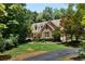 A brick two-story home surrounded by lush green trees and landscaping with a circular driveway at 17 Shotgun Nw Rd, Cartersville, GA 30121