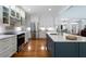 Bright, updated kitchen features stainless steel appliances, an island with seating, and views of the front entrance at 17 Shotgun Nw Rd, Cartersville, GA 30121