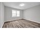 This bedroom features a window and luxury vinyl flooring at 2089 Christian Se Cir, Conyers, GA 30013