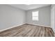 This bedroom features a closet, luxury vinyl flooring and a window at 2089 Christian Se Cir, Conyers, GA 30013
