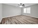 This bedroom features a ceiling fan, luxury vinyl flooring and a window at 2089 Christian Se Cir, Conyers, GA 30013