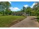 Landscaped front yard leading to a charming single-story home with a long driveway and detached garage at 2089 Christian Se Cir, Conyers, GA 30013