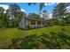 Side view of a newly renovated single-story home with well-maintained lawn and mature trees at 2089 Christian Se Cir, Conyers, GA 30013