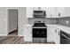Modern kitchen featuring stainless steel appliances and stylish white cabinets at 2089 Christian Se Cir, Conyers, GA 30013