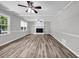 Spacious living room with new floors, painted brick fireplace, recessed lights, and large windows at 2089 Christian Se Cir, Conyers, GA 30013