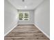 An empty room that features a window and luxury vinyl flooring at 2089 Christian Se Cir, Conyers, GA 30013