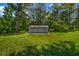 Exterior of a quaint backyard shed that sits in the expansive lawn at 2089 Christian Se Cir, Conyers, GA 30013