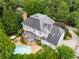 Aerial view of the property featuring a pool, patio, lush greenery, and architectural details at 2878 Wesley Heath Nw, Atlanta, GA 30327