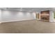 Spacious basement featuring carpet flooring, recessed lighting, and a classic brick fireplace at 2878 Wesley Heath Nw, Atlanta, GA 30327