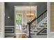 Dining room view from stairway with chandelier, decor wallpaper, window and hardwood floors at 2878 Wesley Heath Nw, Atlanta, GA 30327