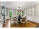 Formal dining room with chandelier, beautiful wallpaper, and large windows providing natural light at 2878 Wesley Heath Nw, Atlanta, GA 30327