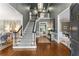 Grand foyer with staircase, hardwood floors, elegant lighting, and views into other rooms at 2878 Wesley Heath Nw, Atlanta, GA 30327