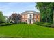 Charming brick home featuring manicured lawn and lush landscaping, offering timeless curb appeal at 2878 Wesley Heath Nw, Atlanta, GA 30327