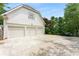 Spacious three-car garage with a wide driveway and well-maintained landscaping at 2878 Wesley Heath Nw, Atlanta, GA 30327