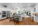 A well-lit kitchen featuring white cabinetry, stainless steel appliances, and a central island with a marble countertop and seating at 2878 Wesley Heath Nw, Atlanta, GA 30327