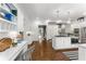 Bright, white kitchen with stainless appliances, decorative lighting, work desk, and a central island featuring a marble countertop at 2878 Wesley Heath Nw, Atlanta, GA 30327