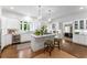 Spacious kitchen featuring white cabinets, marble countertops, stainless appliances, an island with seating, and hardwood floors at 2878 Wesley Heath Nw, Atlanta, GA 30327