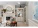 Cozy living room with a fireplace, built-in shelving, a decorative mirror, and comfortable seating arrangements at 2878 Wesley Heath Nw, Atlanta, GA 30327