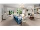 Bright living room with a fireplace, built-in shelving, large windows offering backyard views, and stylish decor and furnishings at 2878 Wesley Heath Nw, Atlanta, GA 30327