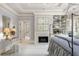 Elegant main bedroom with a fireplace, built-in shelving, neutral walls, and a canopy bed, creating a cozy, inviting atmosphere at 2878 Wesley Heath Nw, Atlanta, GA 30327