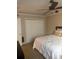 Neutral bedroom featuring a ceiling fan, closet, and comfortable bed with white comforter at 3120 Seven Pines Court # 203, Atlanta, GA 30339