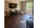 Living room featuring wood floors, modern decor, and sliding glass door at 3120 Seven Pines Court # 203, Atlanta, GA 30339
