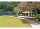 Community pavilion with seating area, mature trees, and walkway to the tennis court at 3120 Seven Pines Court # 203, Atlanta, GA 30339