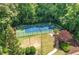 Aerial view of the community tennis court surrounded by lush greenery and a walkway at 3120 Seven Pines Court # 203, Atlanta, GA 30339