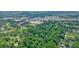 An aerial view of a neighborhood, showcasing tree-lined streets, a community with schools and shopping nearby at 588 Benson Hurst Dr, Mableton, GA 30126