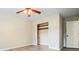 Bedroom with ceiling fan, closet and a window, showcasing natural light and a minimalist style at 588 Benson Hurst Dr, Mableton, GA 30126