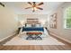Spacious main bedroom with neutral walls, ceiling fan, natural light, and hardwood floors, creating a serene retreat at 588 Benson Hurst Dr, Mableton, GA 30126