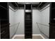 Walk-in closet featuring dark wood shelving, hanging rods, and plenty of storage space at 588 Benson Hurst Dr, Mableton, GA 30126