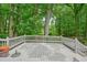 Expansive white deck with a picturesque view of the surrounding green forest at 588 Benson Hurst Dr, Mableton, GA 30126