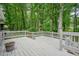 Spacious white wooden deck overlooking a lush, green wooded area at 588 Benson Hurst Dr, Mableton, GA 30126