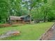 Charming single-Gathering home surrounded by lush greenery and a well-maintained lawn at 588 Benson Hurst Dr, Mableton, GA 30126